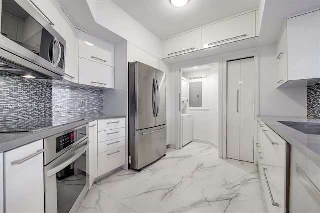 kitchen featuring tasteful backsplash, white cabinets, and stainless steel appliances