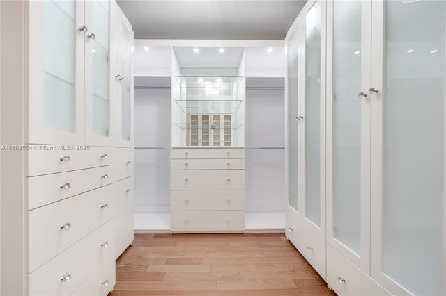 walk in closet featuring light hardwood / wood-style flooring