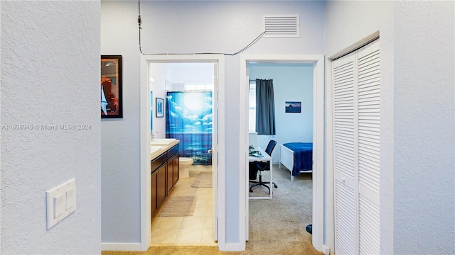 corridor with light colored carpet