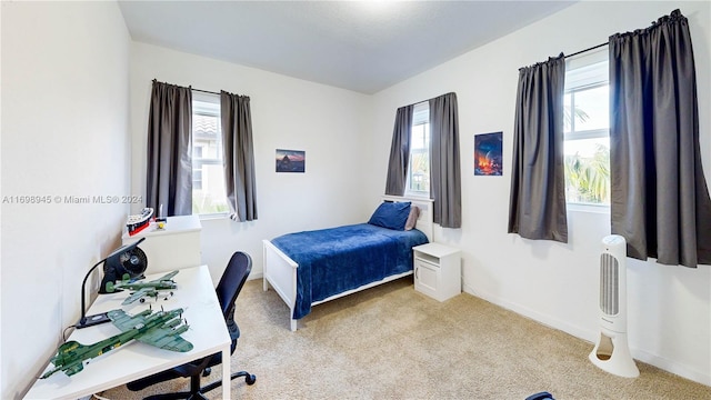 carpeted bedroom featuring multiple windows