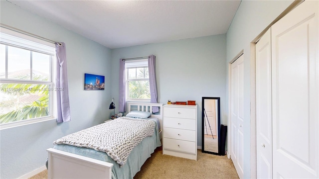 bedroom featuring light colored carpet