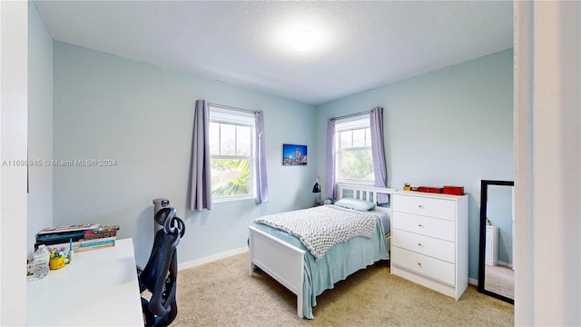 carpeted bedroom with a textured ceiling