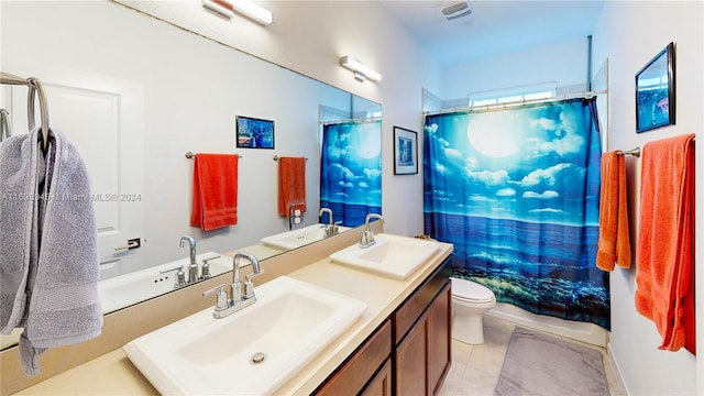 bathroom with tile patterned floors, curtained shower, vanity, and toilet