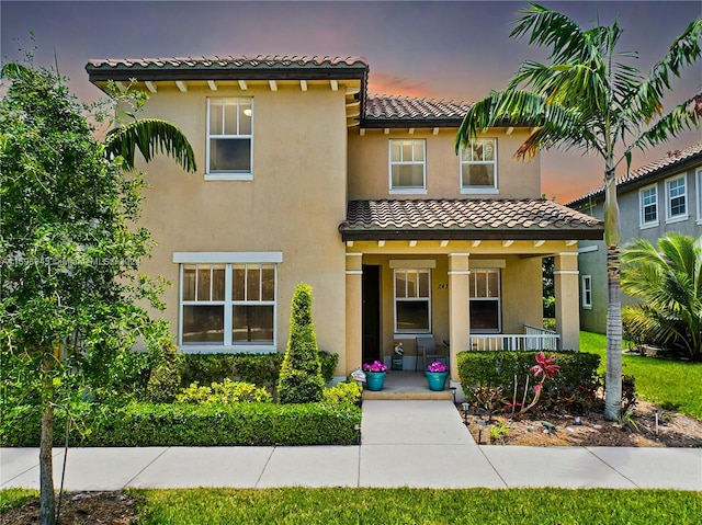 mediterranean / spanish-style home with a porch