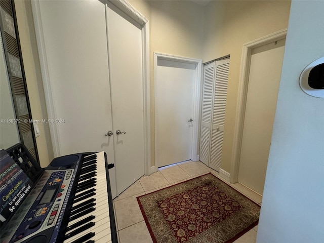 hall with light tile patterned floors