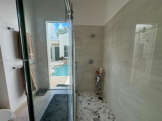 bathroom featuring tile patterned floors and a shower with door