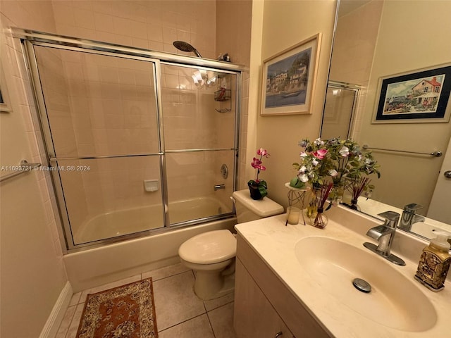 full bathroom with shower / bath combination with glass door, tile patterned flooring, vanity, and toilet