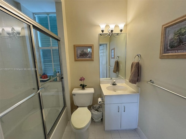 full bathroom with tile patterned floors, vanity, combined bath / shower with glass door, and toilet