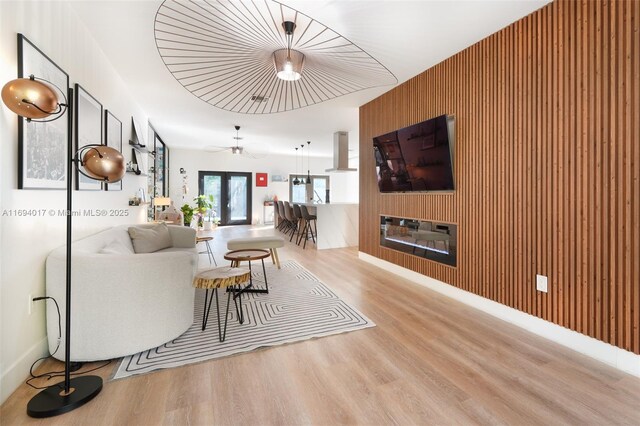 living room with ceiling fan, light wood-type flooring, and french doors