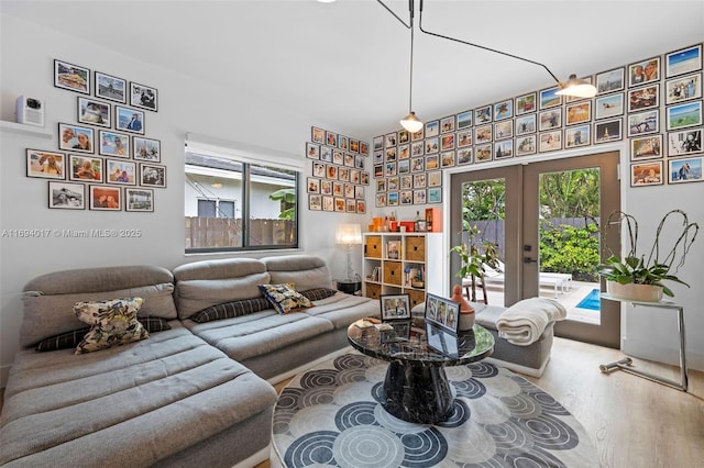 living room featuring french doors, hardwood / wood-style flooring, and a wealth of natural light