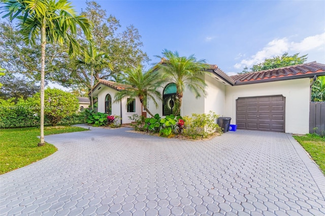 mediterranean / spanish-style home with a garage