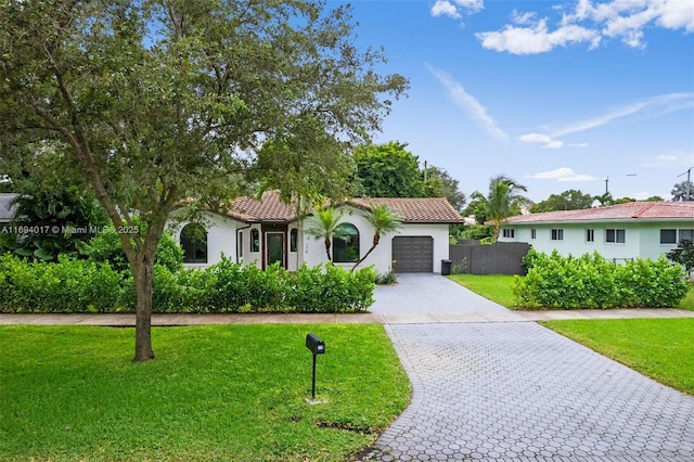 view of front facade featuring a garage and a front yard