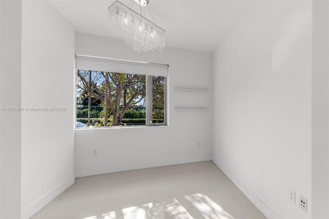 unfurnished room with an inviting chandelier