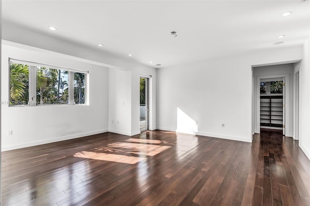 empty room with dark hardwood / wood-style floors