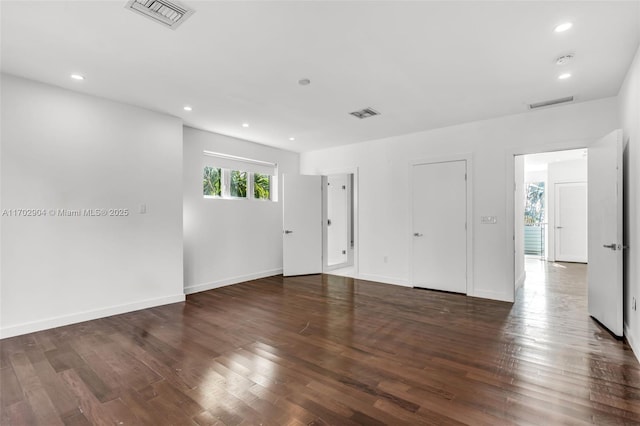 spare room featuring dark wood-type flooring