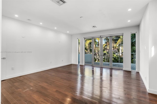 unfurnished room with dark wood-type flooring and french doors