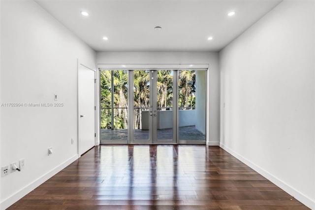 empty room featuring french doors and dark hardwood / wood-style floors