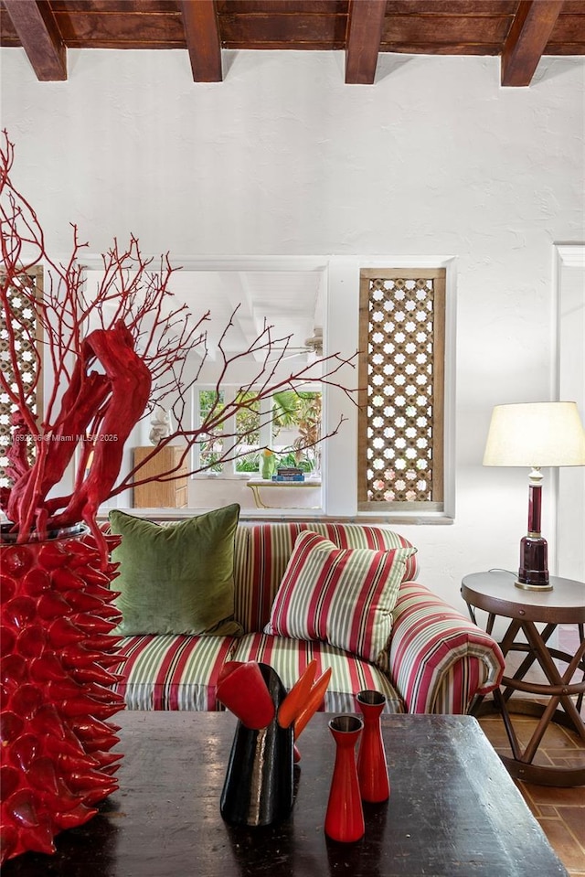 sitting room featuring beam ceiling