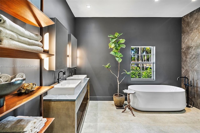 bathroom featuring a tub, vanity, and concrete floors