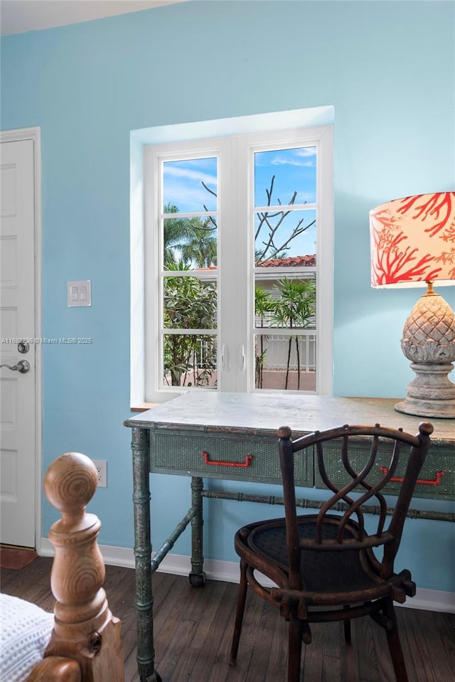 dining room featuring wood finished floors and baseboards