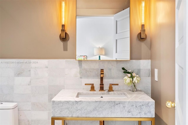 bathroom with decorative backsplash, vanity, and toilet