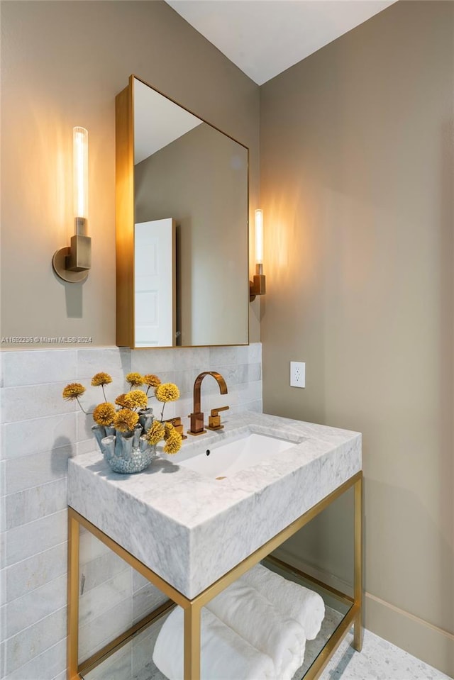 bathroom with backsplash and sink