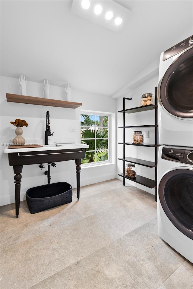 washroom featuring stacked washer and clothes dryer