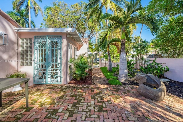 view of patio with french doors and fence