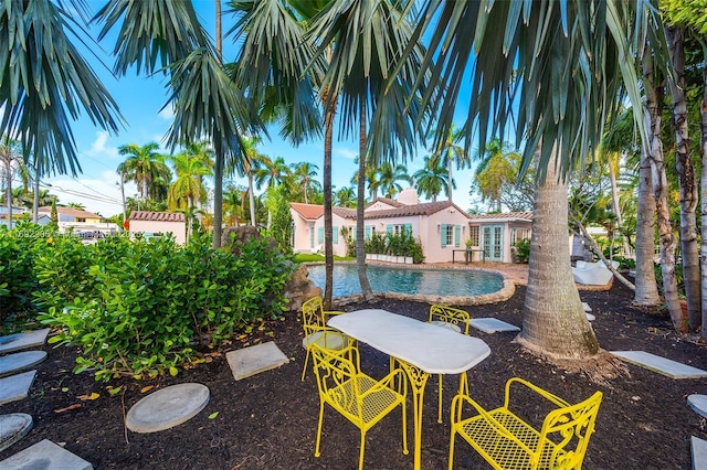 outdoor pool featuring french doors