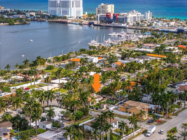 birds eye view of property featuring a water view and a city view