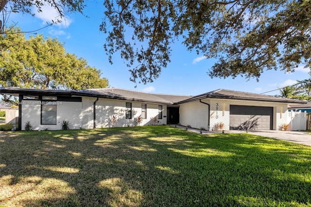 ranch-style house featuring a garage and a front yard