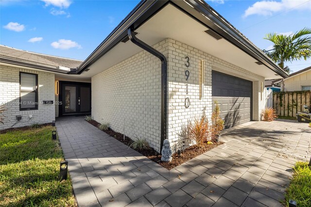 ranch-style home featuring a front yard and a garage