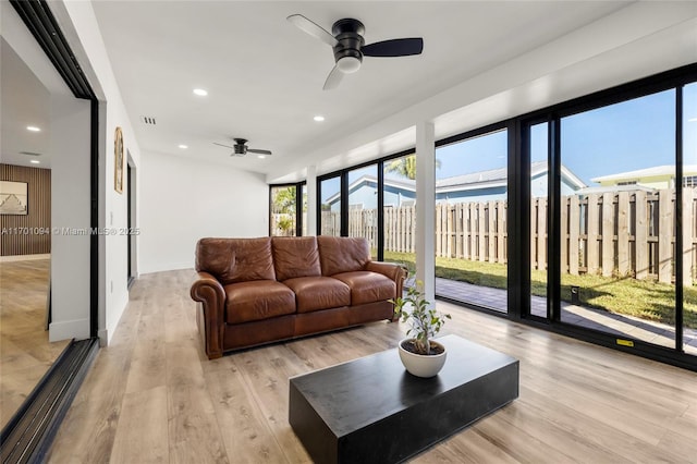 living area featuring ceiling fan, light wood-type flooring, visible vents, and recessed lighting