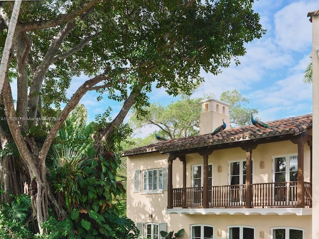 rear view of house featuring a balcony