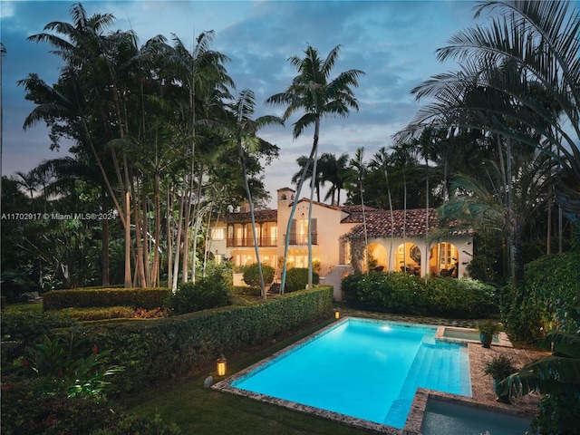 view of pool at dusk