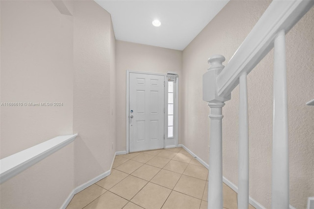 foyer entrance with light tile patterned floors