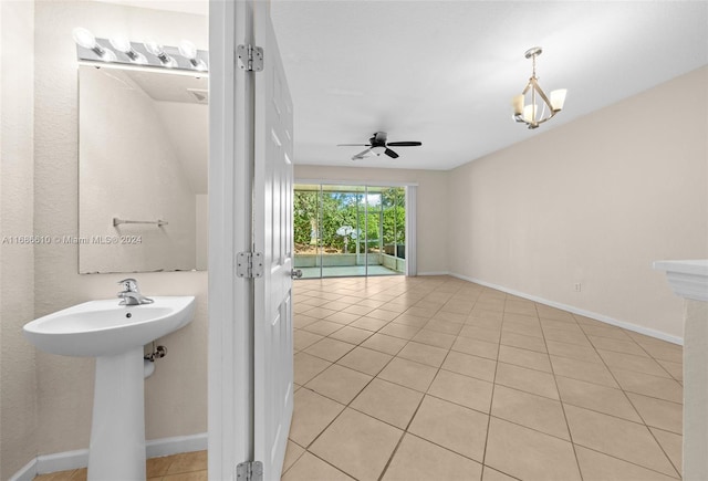 bathroom featuring tile patterned flooring and ceiling fan with notable chandelier