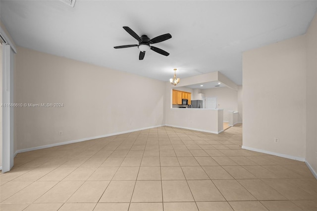 unfurnished living room with ceiling fan with notable chandelier and light tile patterned floors