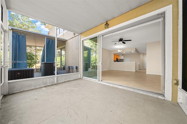 unfurnished sunroom featuring ceiling fan