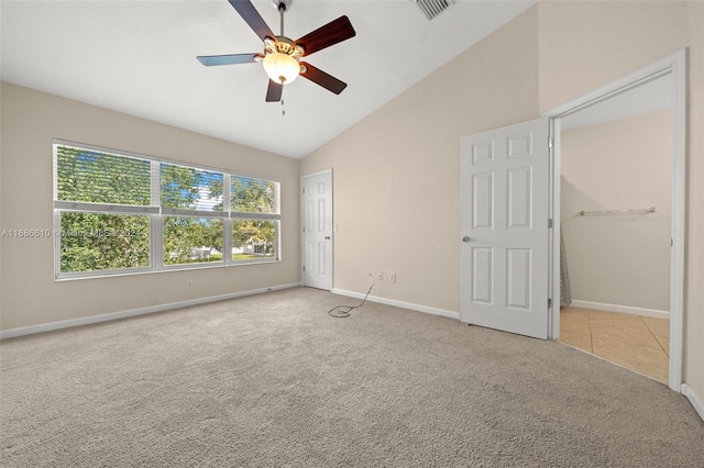 unfurnished bedroom featuring ceiling fan, high vaulted ceiling, and light colored carpet