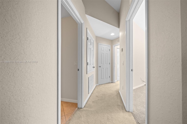 corridor with light colored carpet