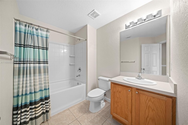 full bathroom featuring tile patterned floors, a textured ceiling, toilet, vanity, and shower / tub combo