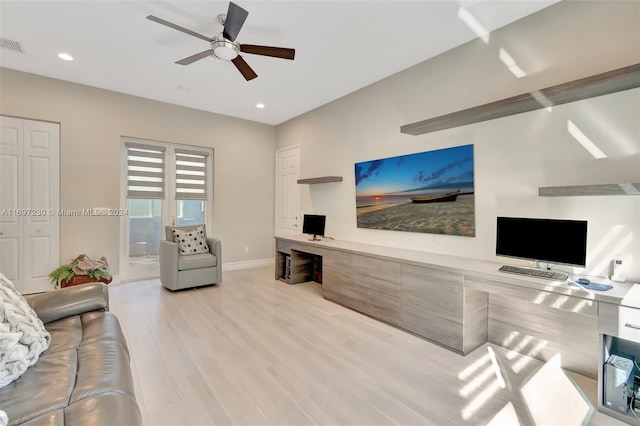 living room with light wood-type flooring and ceiling fan