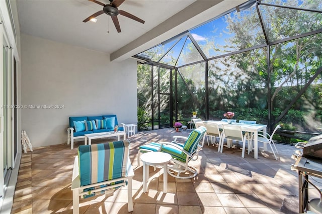 view of patio with ceiling fan, a lanai, and an outdoor living space