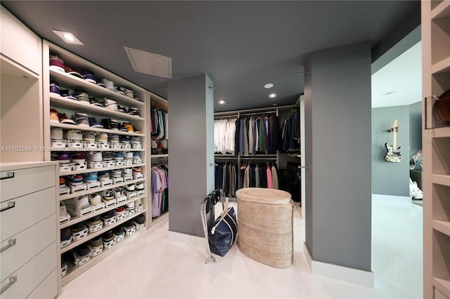 spacious closet with light tile patterned floors