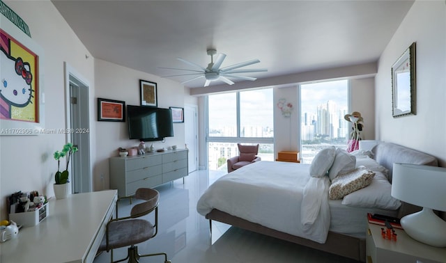 bedroom with ceiling fan, light tile patterned floors, and multiple windows