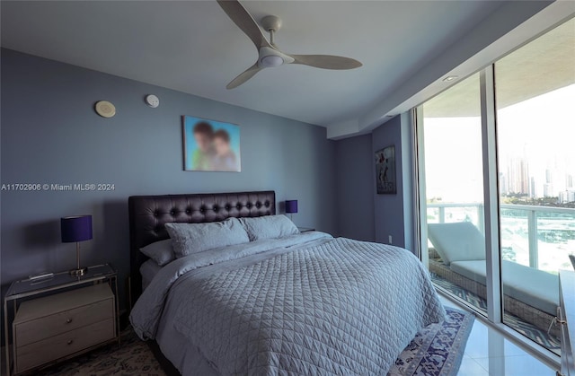 tiled bedroom with ceiling fan and access to outside