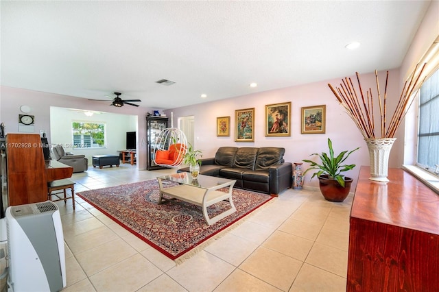 tiled living room featuring ceiling fan