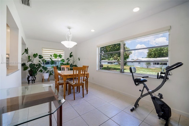 dining room with a wealth of natural light and light tile patterned floors