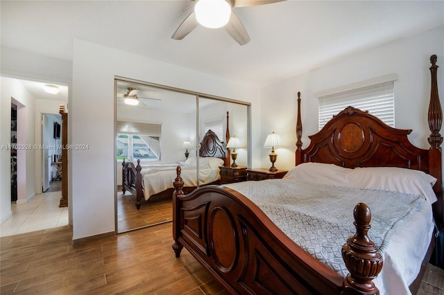 bedroom with a closet, ceiling fan, and hardwood / wood-style floors